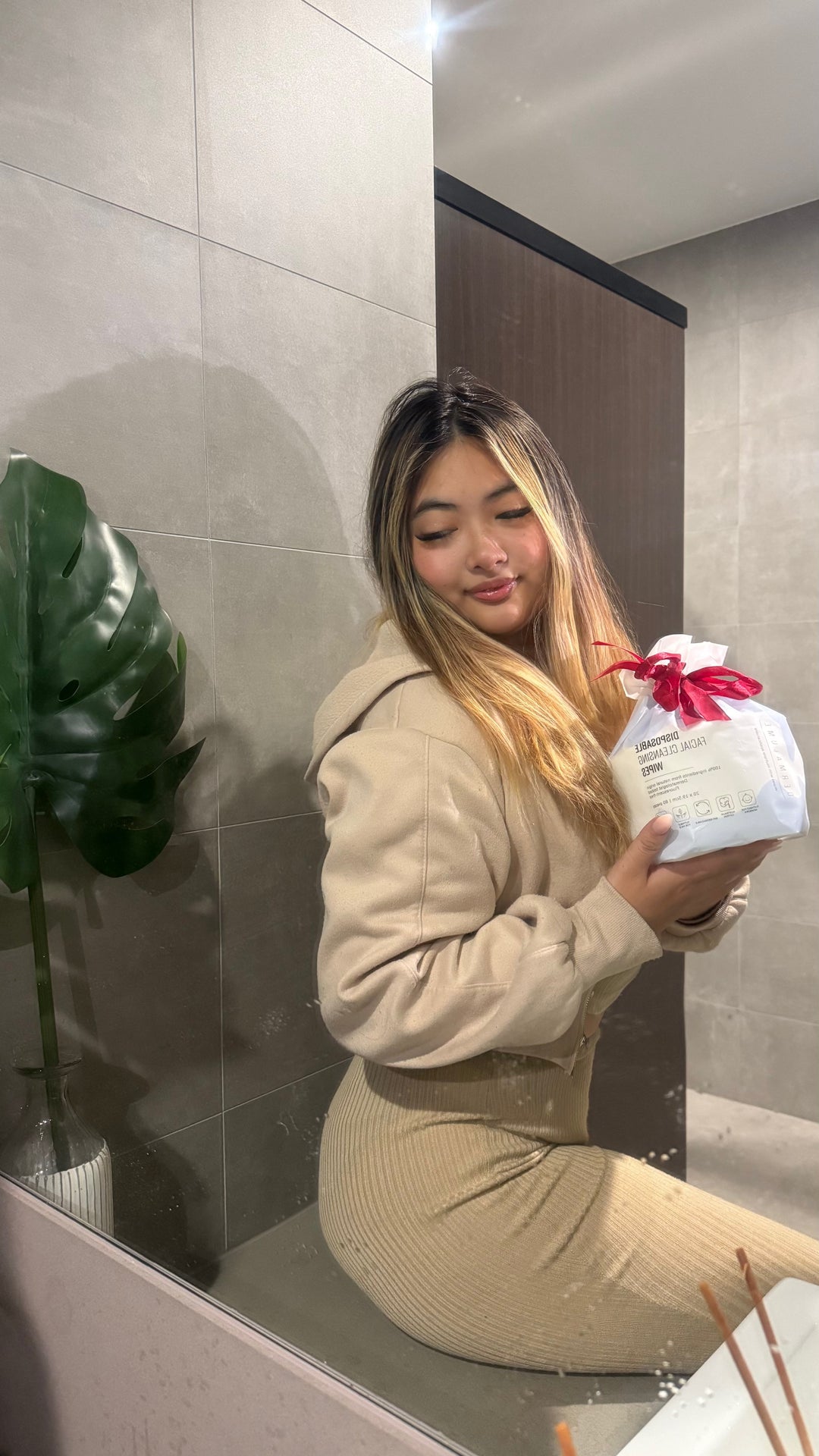 a girl holding Dermalume Disposable Facial Towel 